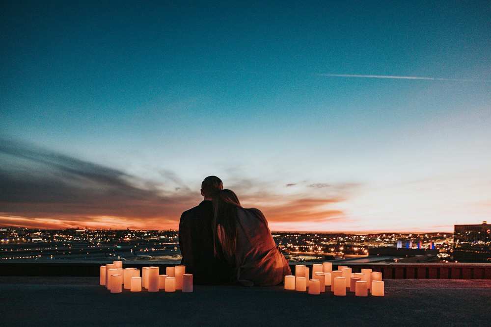 Candles laid out for a proposal at sunset